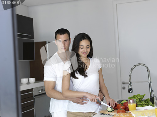 Image of happy young couple in kicthen