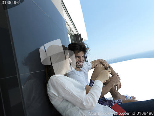 Image of young couple making selfie together at home