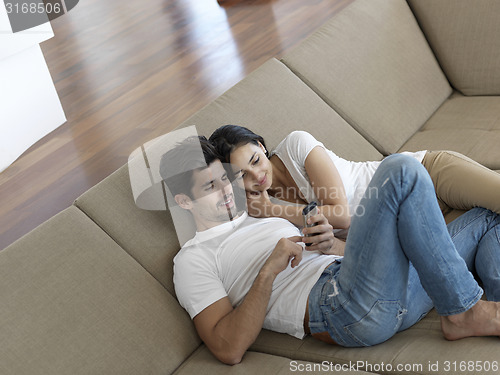 Image of young couple making selfie together at home