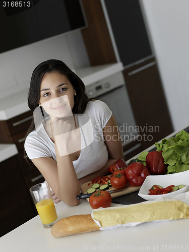 Image of Young Woman Cooking in the kitchen