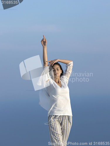 Image of young woman enjoy sunset