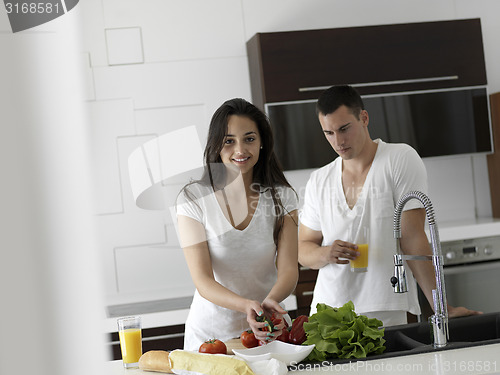 Image of happy young couple in kicthen