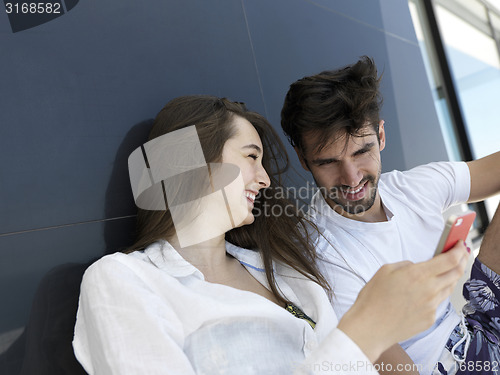 Image of young couple making selfie together at home