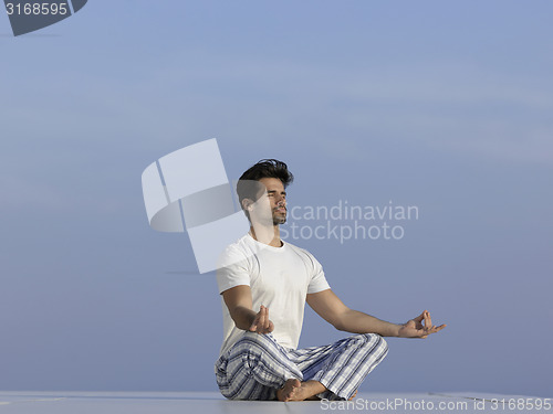 Image of young man practicing yoga