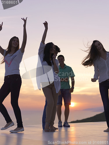 Image of party people  on sunset