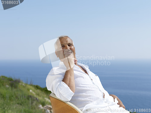 Image of senior man sitting outside