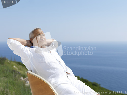 Image of senior man sitting outside