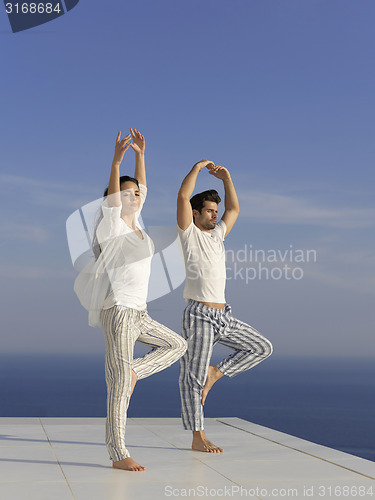 Image of young couple practicing yoga