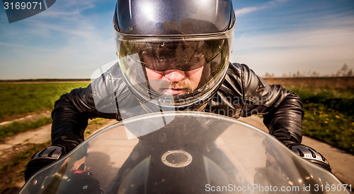 Image of Biker racing on the road