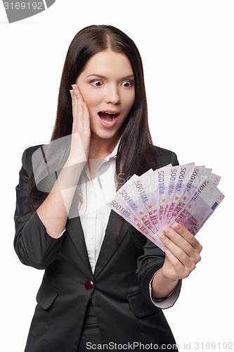 Image of Excited woman with euro money in han