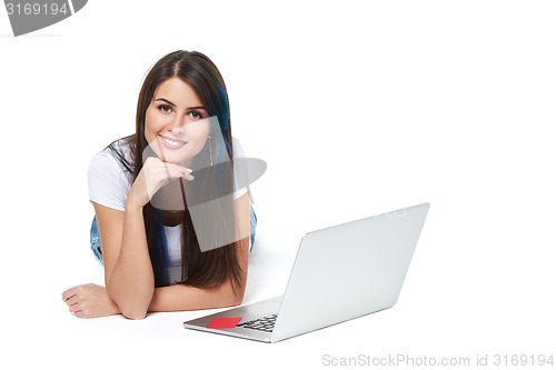 Image of Woman lying on the floor with laptop