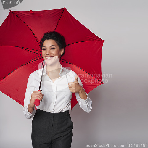Image of Happy woman with umbrella