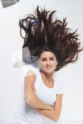 Image of Top view of  woman lying on floor on back