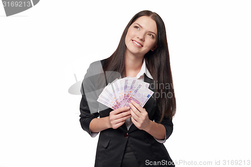 Image of Dreamy woman holding euro money