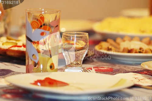 Image of crockery glass plate wine-glass on served table