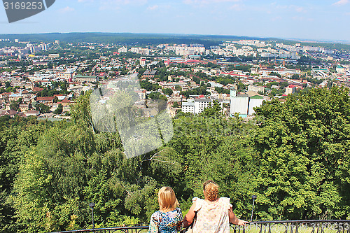 Image of two women watching to open space above Lvov city