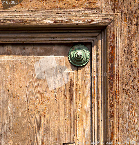 Image of  knocker in a  door curch   italy  varese lonate pozzolo