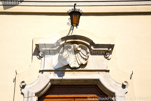 Image of  church door   in italy  lombardy   shell street lamp