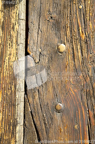 Image of  in a the mozzate rusty    door curch  closed wood italy  lombar