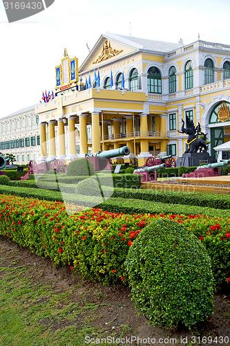 Image of   cannon bangkok in thailand   flag flower  temple steet