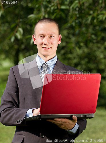 Image of Man working outdoors as a freelancer