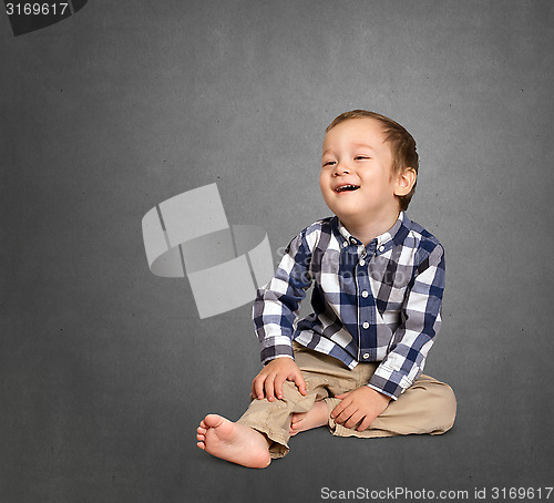 Image of Cute boy siting on the floor