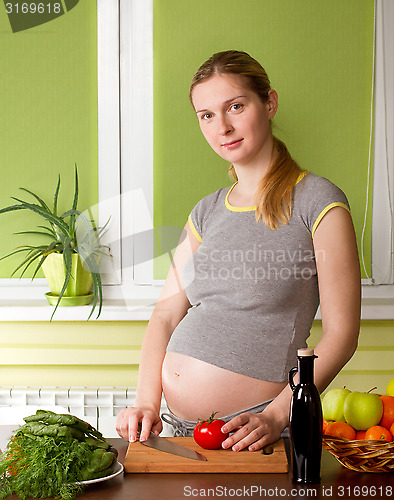 Image of Pregnant woman on kitchen cooking