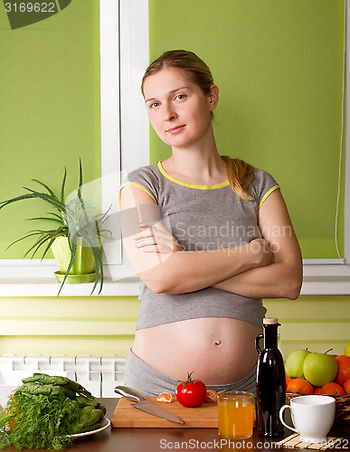 Image of Pregnant woman on kitchen cooking