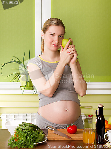 Image of Pregnant woman on kitchen cooking