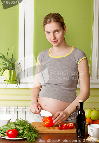 Image of Pregnant woman on kitchen cooking