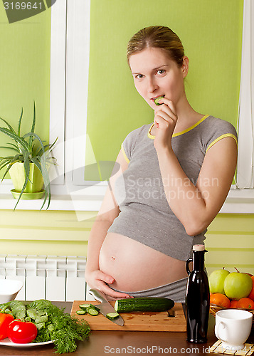 Image of Pregnant woman on kitchen cooking