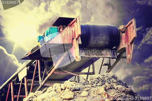 Image of Conveyor against stormy cloudscape