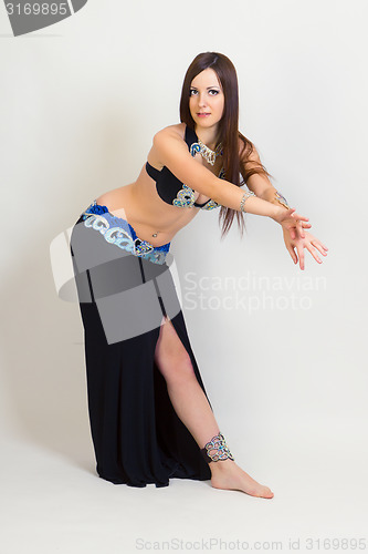 Image of young woman a performing belly dancing. full height