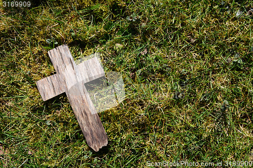 Image of Small cross on grass and moss