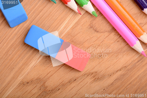 Image of colored pencils  on wooden background