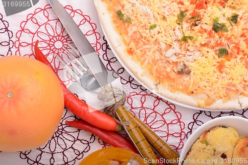 Image of Beef pizza with meat chop and mandarin