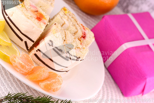 Image of sweet cake on white plate and fruits