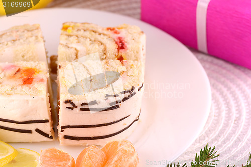 Image of sweet cake on white plate and fruits