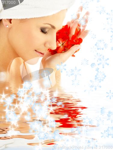 Image of lady with red petals and snowflakes in water