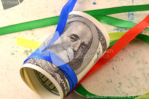 Image of Bundle of dollars tied with ribbon