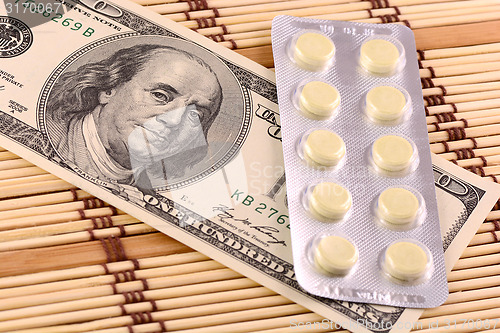 Image of Pills and american money close-up background
