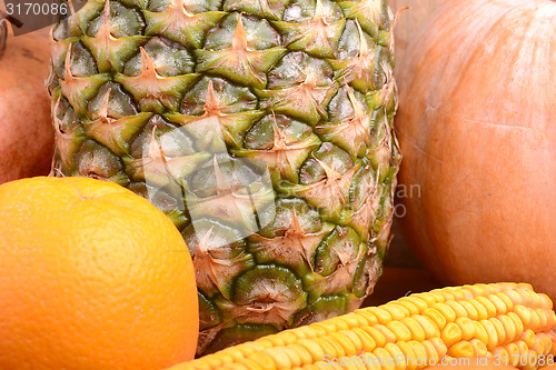 Image of fresh pineapple with corn and orange