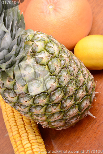 Image of fresh pineapple with corn and orange
