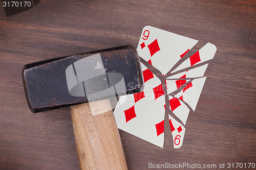 Image of Hammer with a broken card, nine of diamond