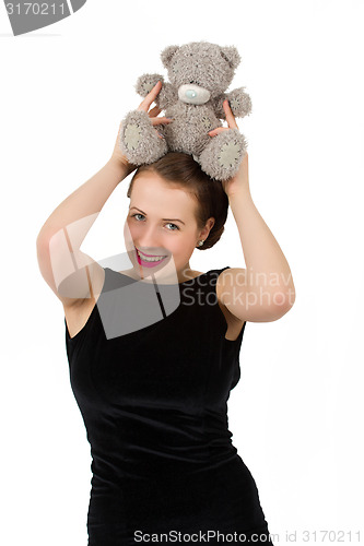 Image of attractive smiling brunette holding teddy bear