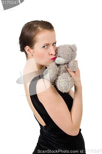 Image of attractive smiling brunette holding teddy bear