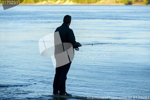 Image of Modern clean fishing rod in hands