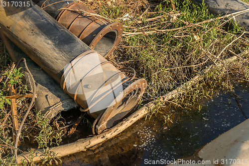 Image of Rusty metal pipes in the forest