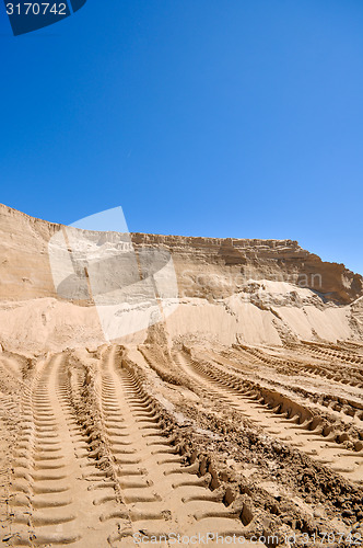 Image of sand pit with traces of tractor