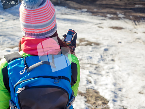 Image of Hiker tracks his position at the gps